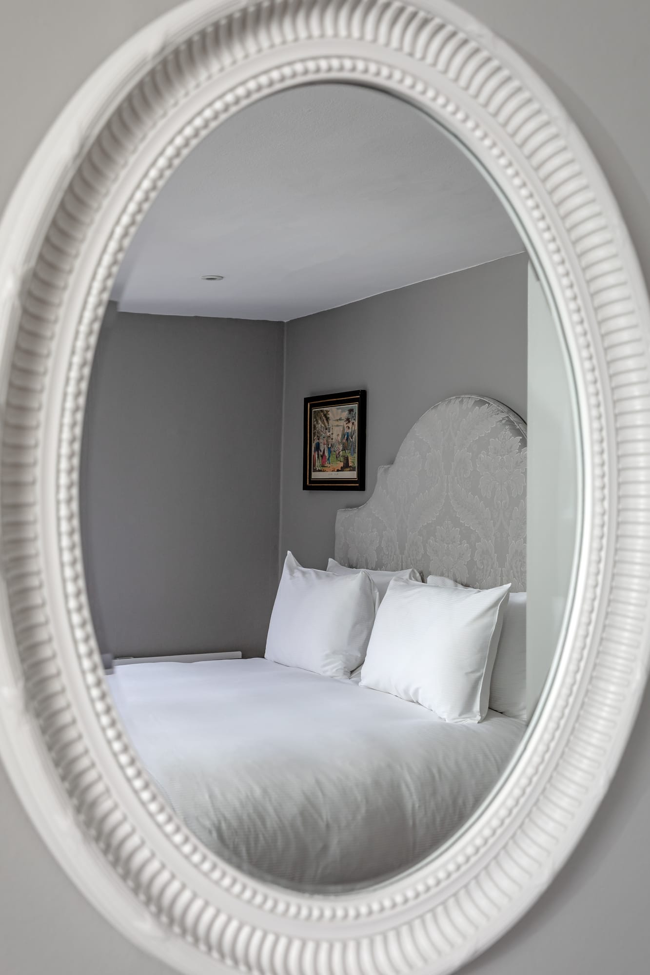 Suite bedroom reflected in a mirror at No. 30 Knightsbridge